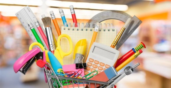 Shopping cart with colorful school stationery, back to school background